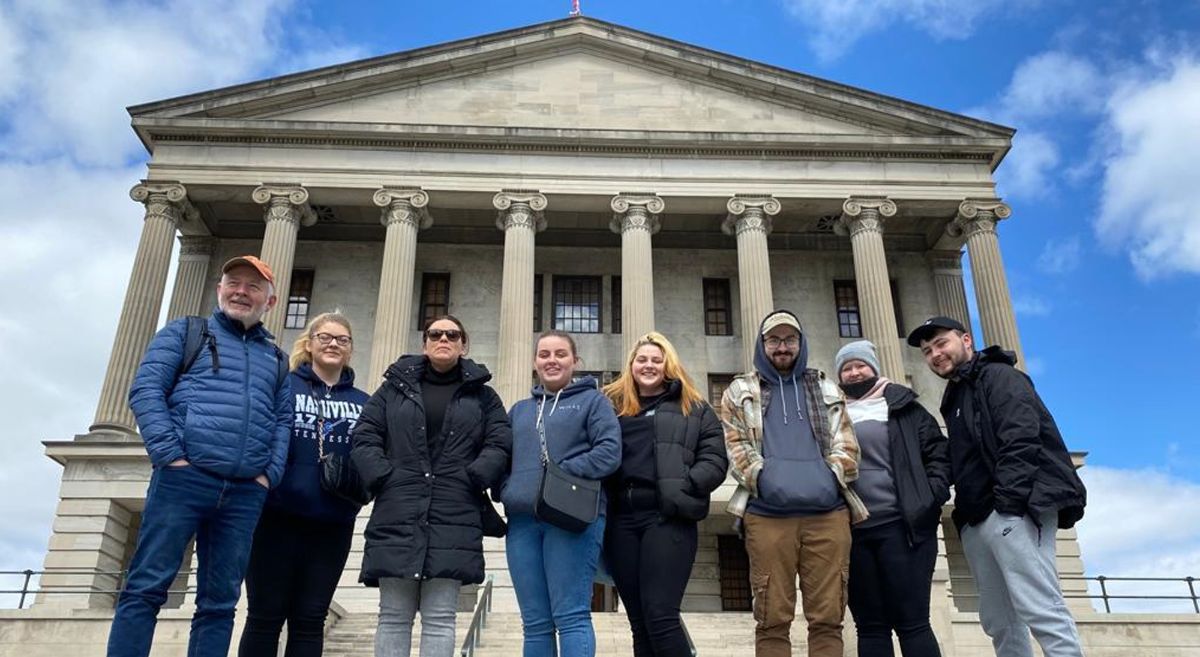 Lecturer and seven students pictured with Tennessee State Capitol building in background